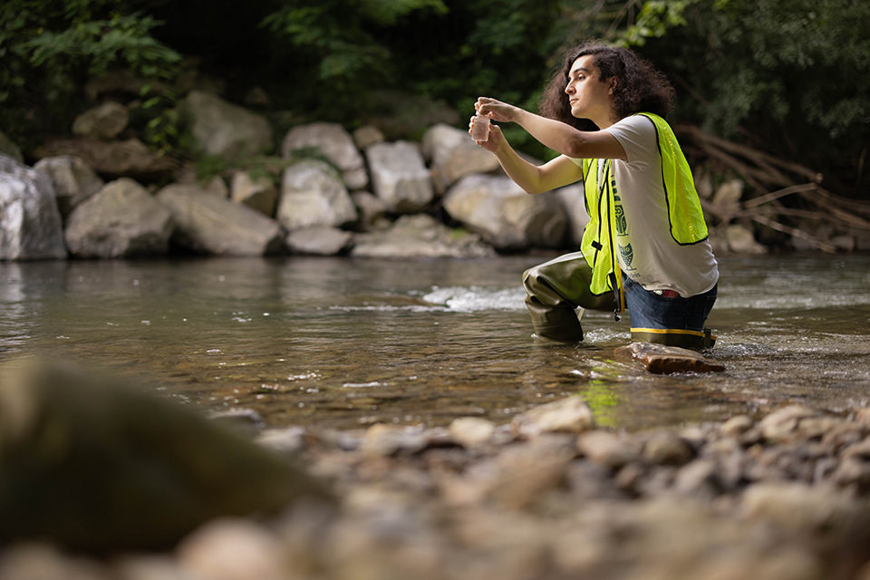 Forman collecting a water sample