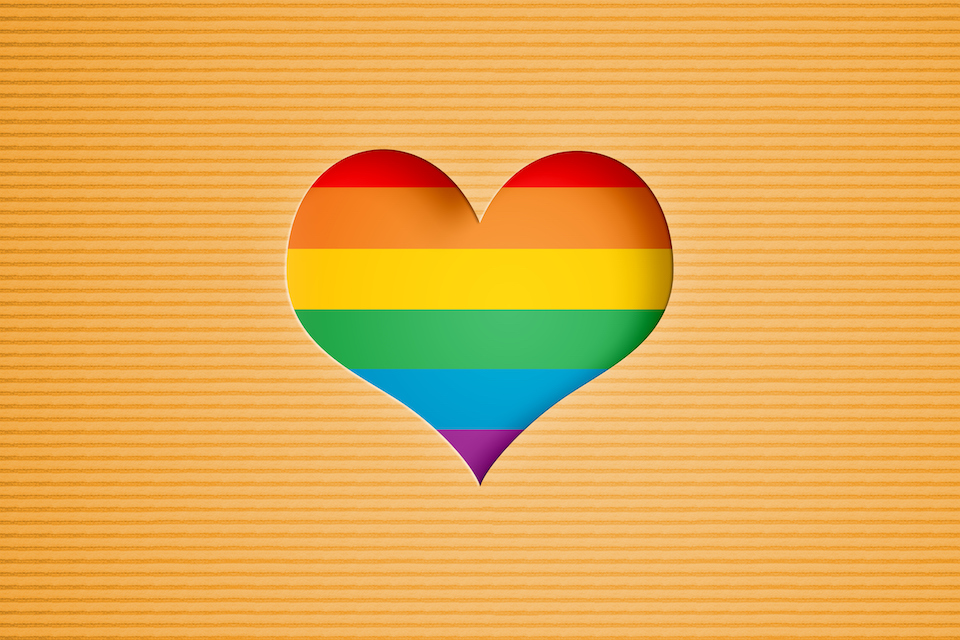 illustration. A heart shape with rainbow colored stripes.