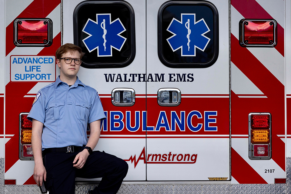 Lorrin Stone poses by armstrong ambulance