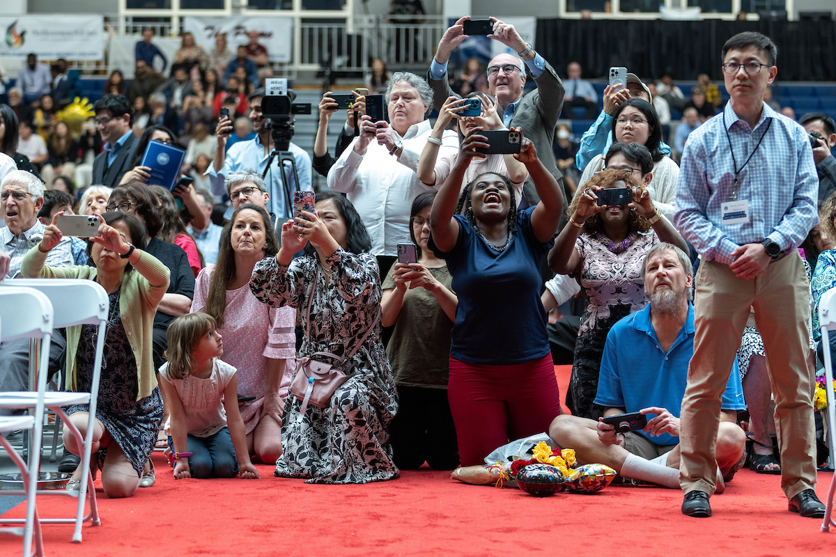 Parents take photos of graduates.