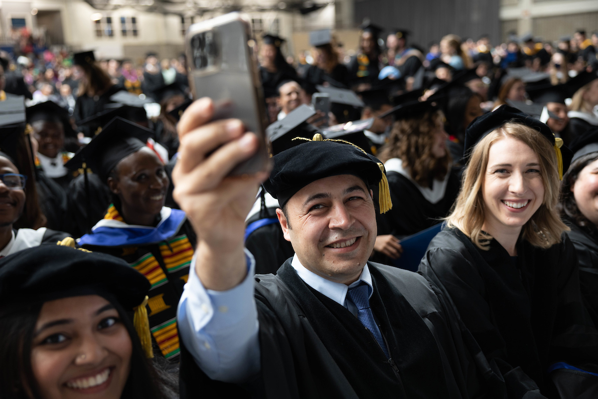 Grads take selfies together.