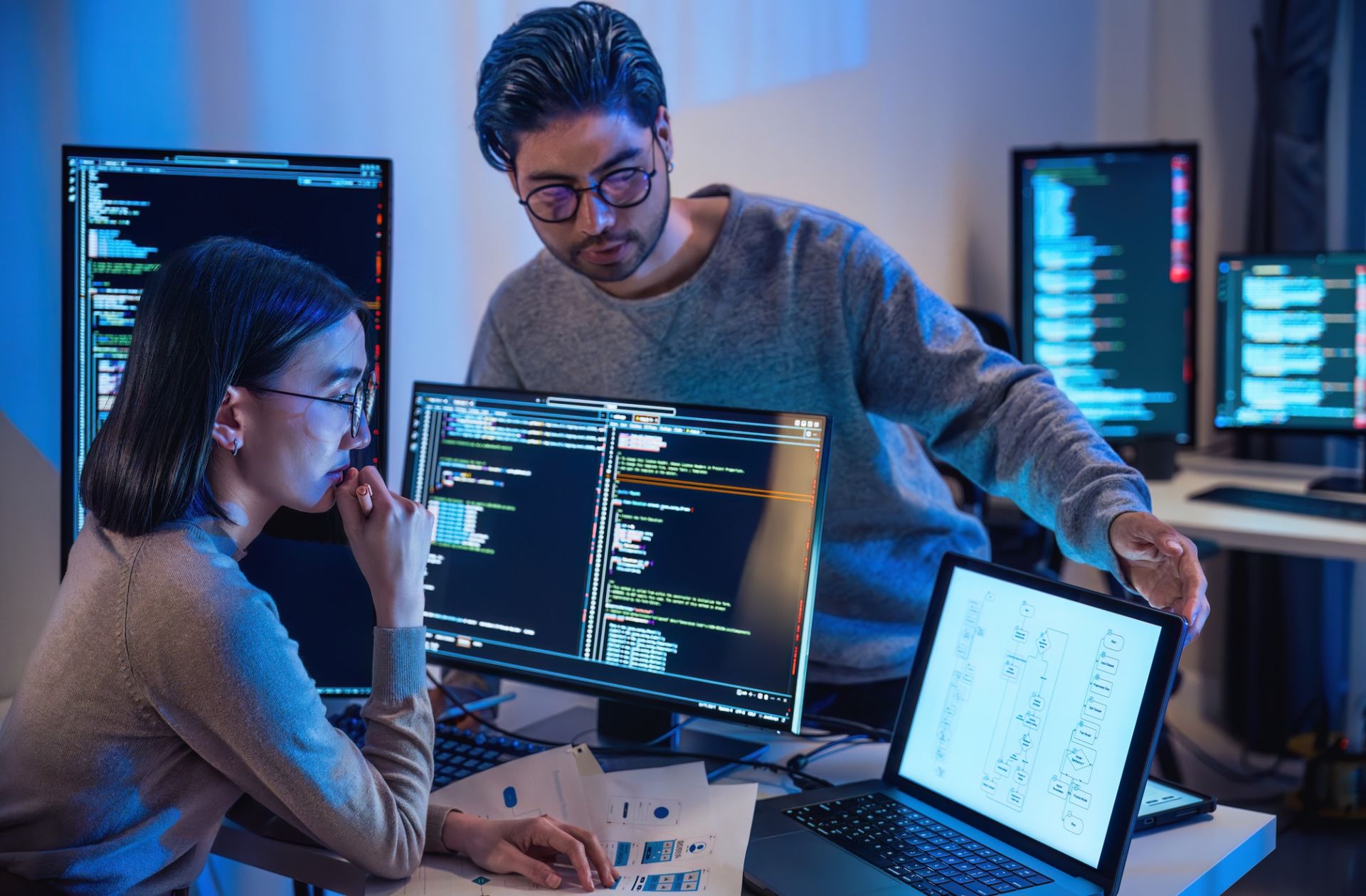 Man and woman looking at computer screens