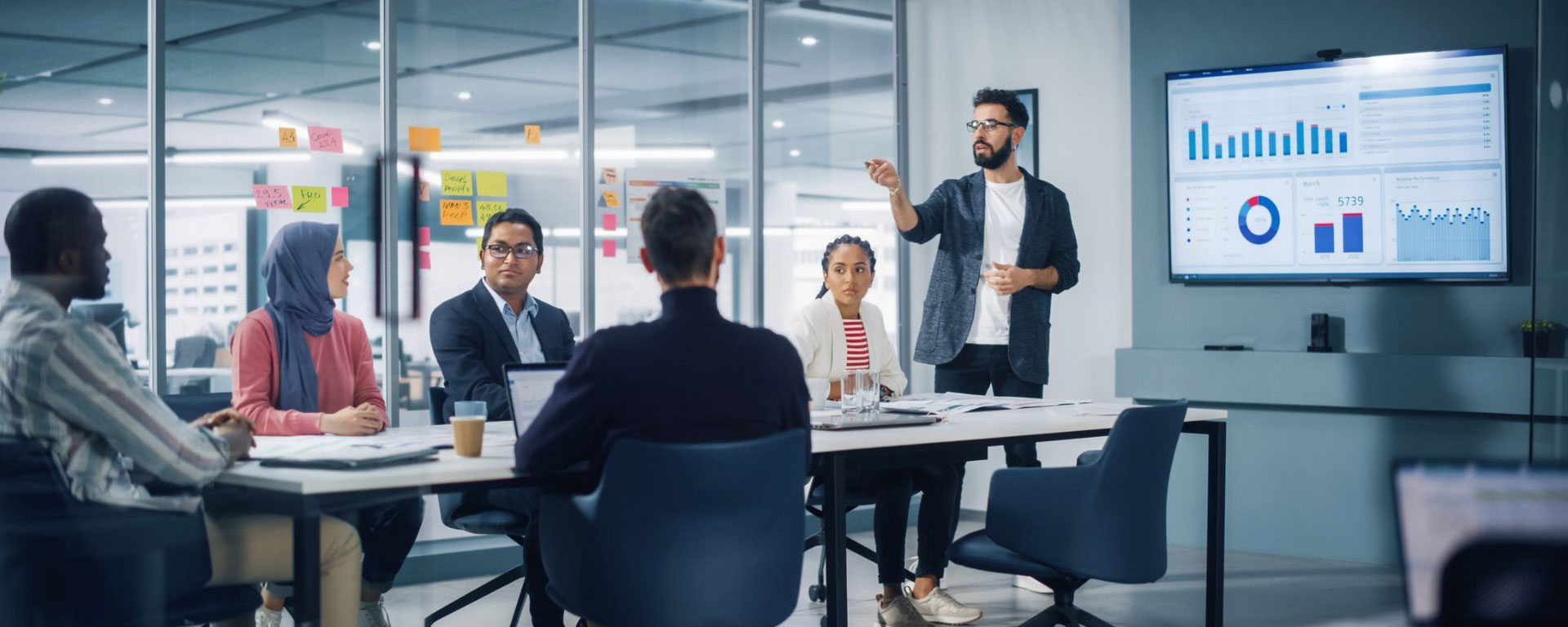 Two scientists in a lab looking at a smartboard