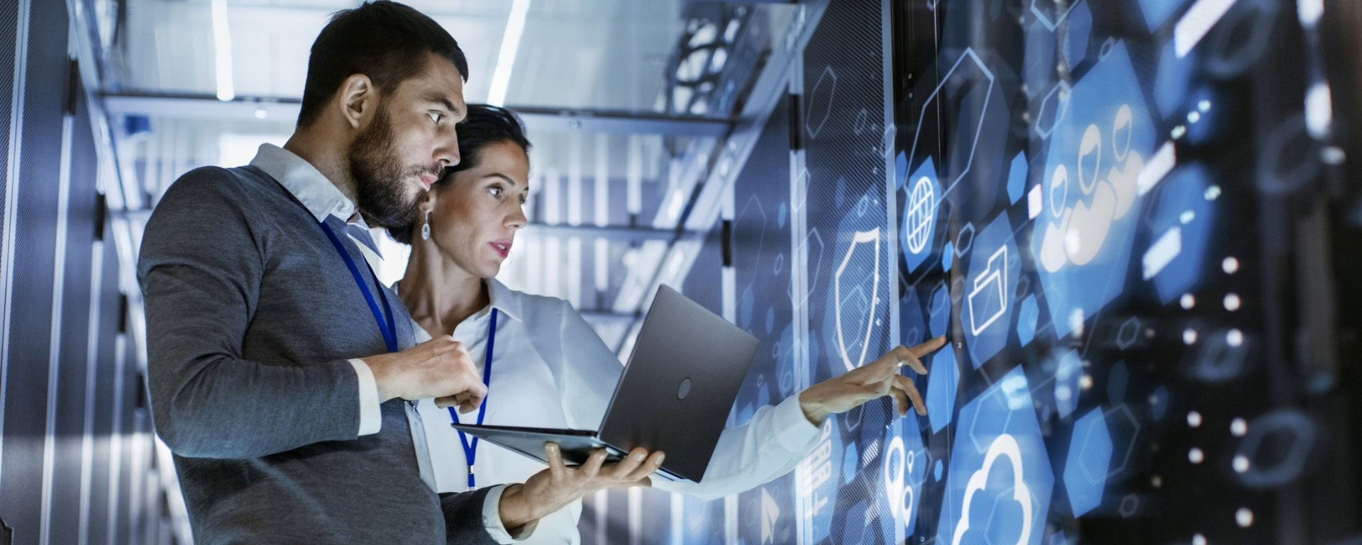 Two scientists in a lab looking at a smartboard