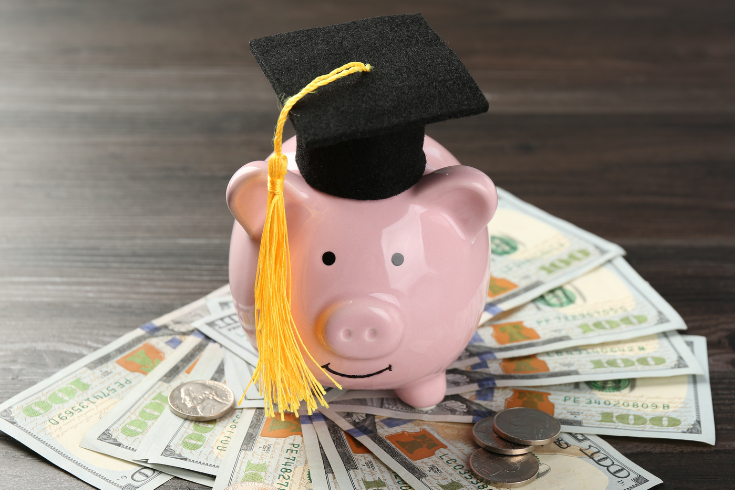 piggy bank wearing a graduation cap