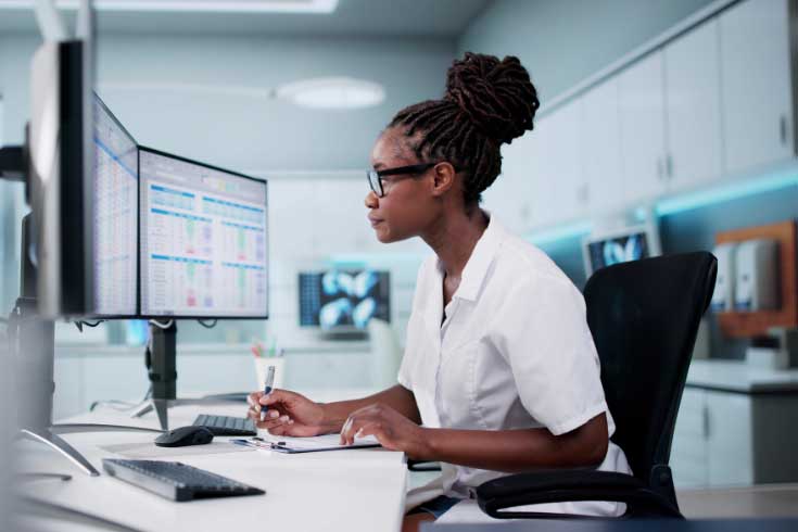 Person looking at a computer monitor with data displayed