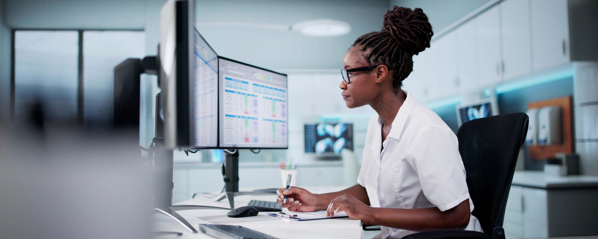 Person looking at a computer monitor with data displayed on it