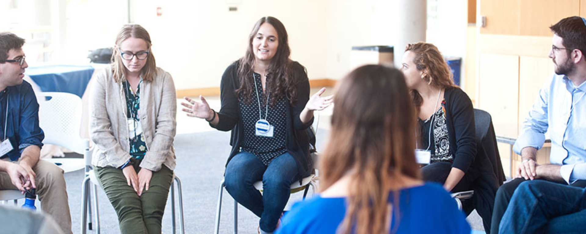 Professionals gather in a circle for a discussion