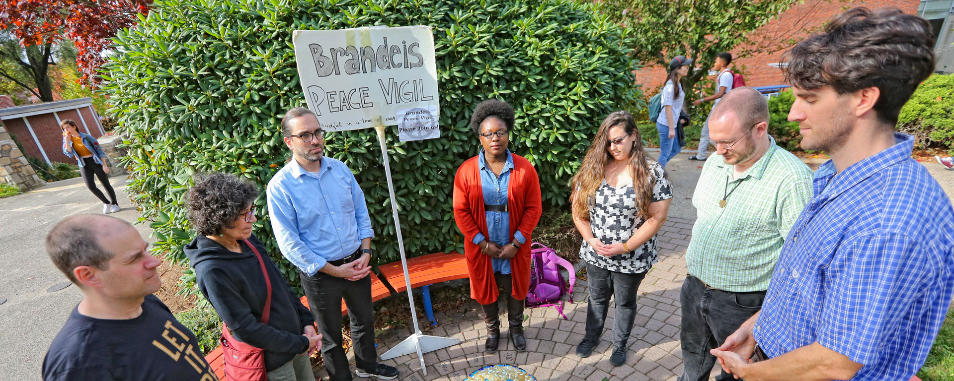 People stand in a group during a Peace Vigil