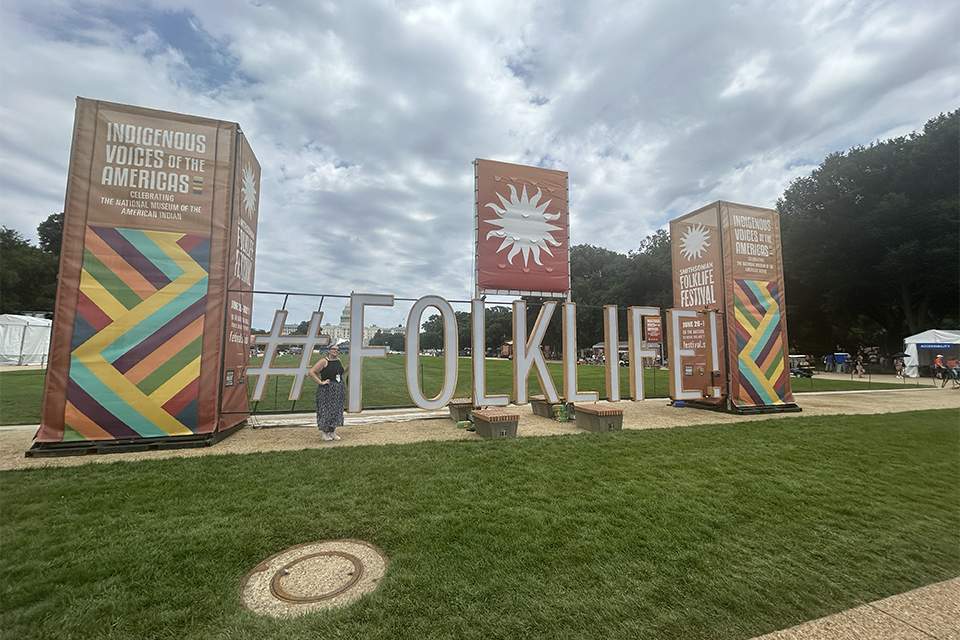 Sophia Fedus at the Festival #Folklife sign on the National Mall, 2024