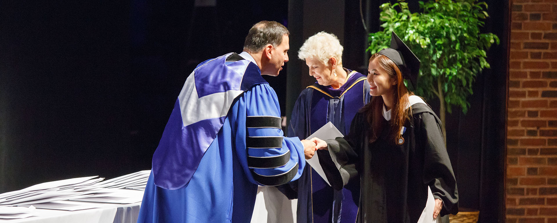 President Ronald Liebowitz congratulates a newly minted Phi Beta Kappa member during the 2018 induction ceremony.