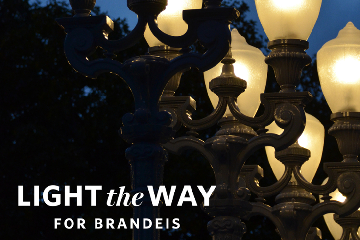 lighted lamps plus the words "light the way for brandeis"