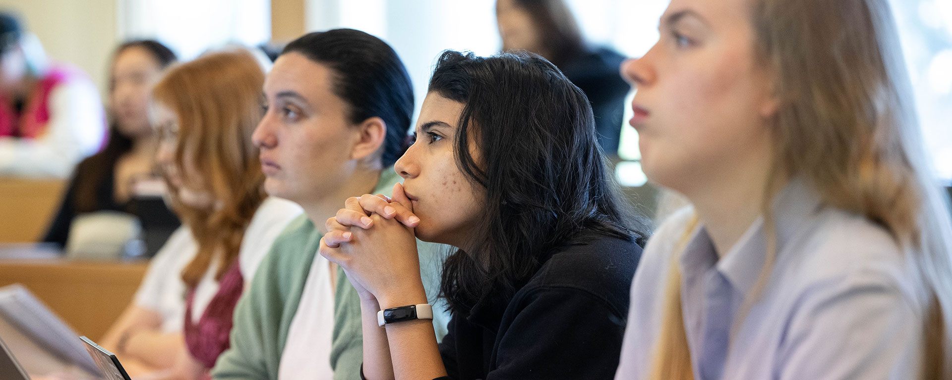 Students sit in a classroom and listen to a philosophy lecture.