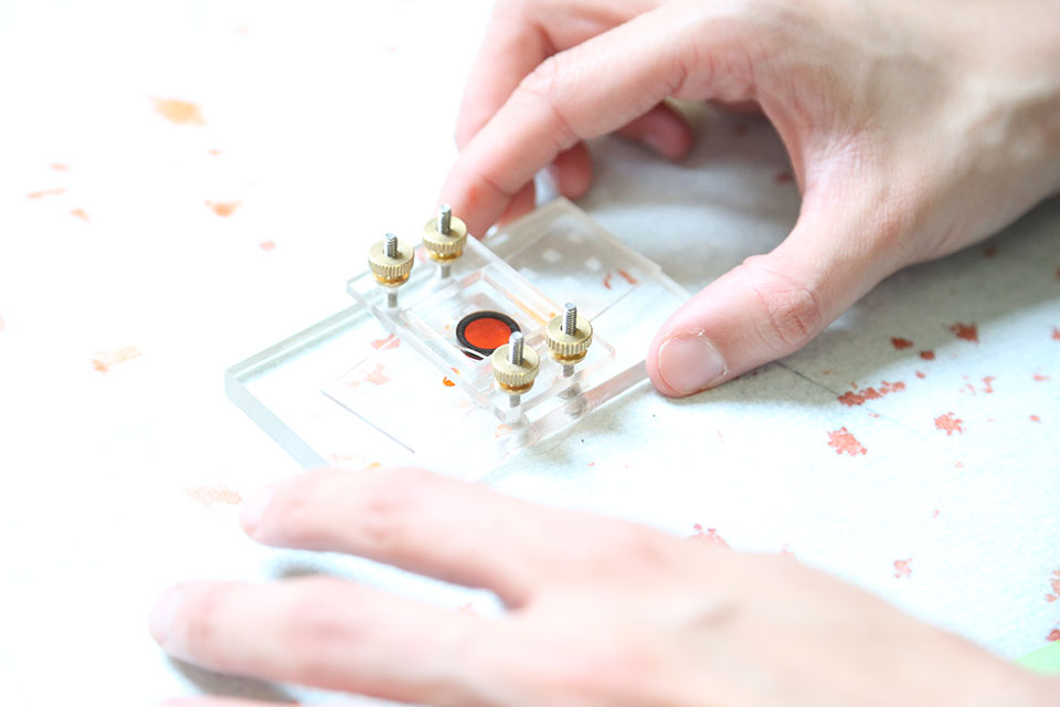 Hands using an instrument in a lab