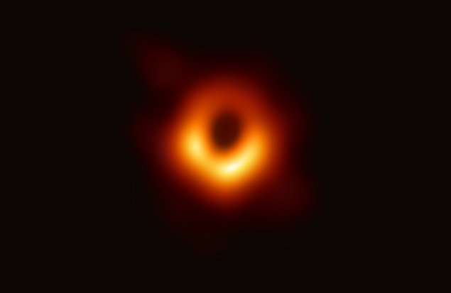 First photograph of black hole; bright orange glowing orbiting gas against black sky