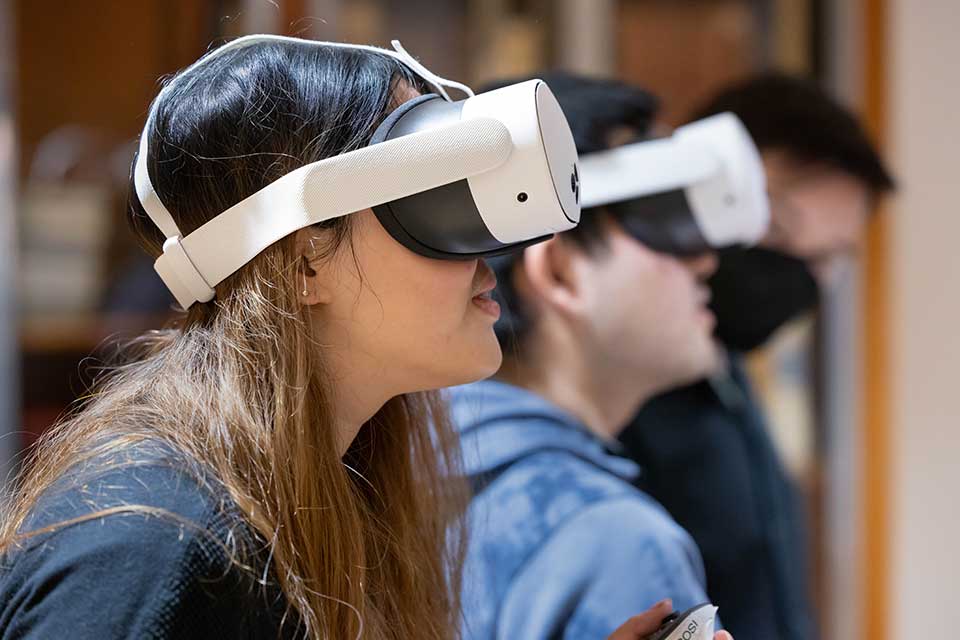 Students wear virtual reality goggles.