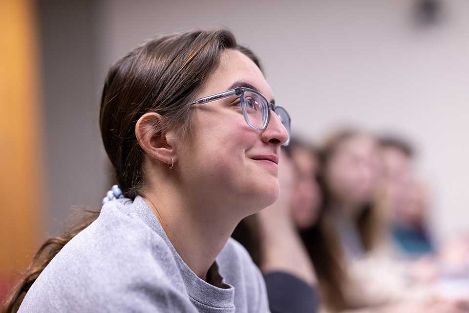 Student engaged in class, smiling