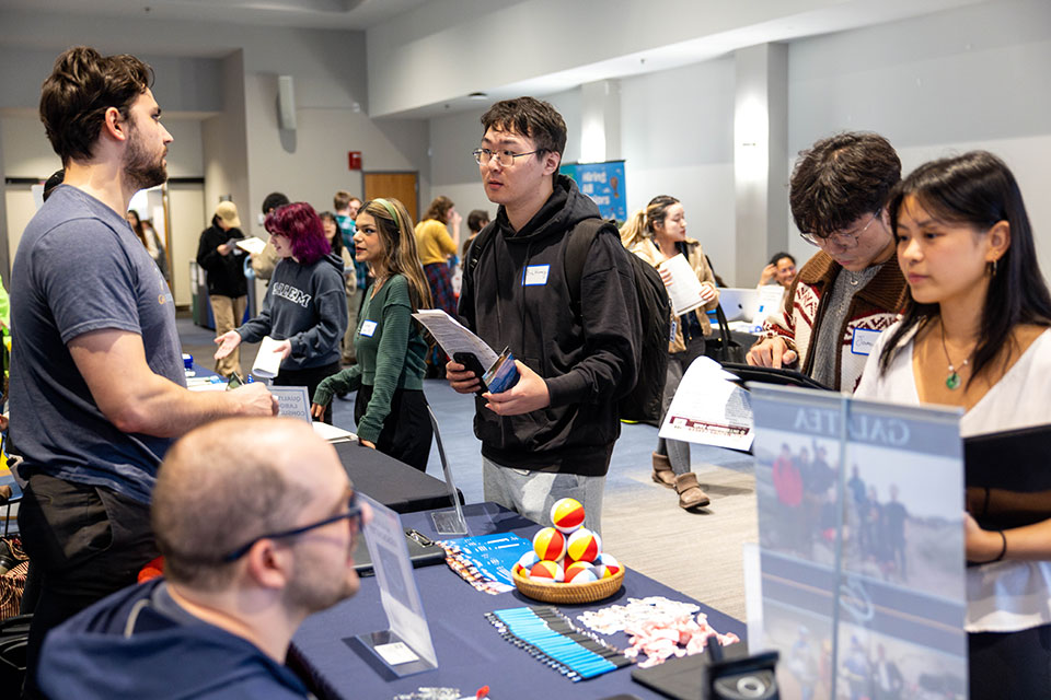 Students speak with recruiters as a career development event on campus.