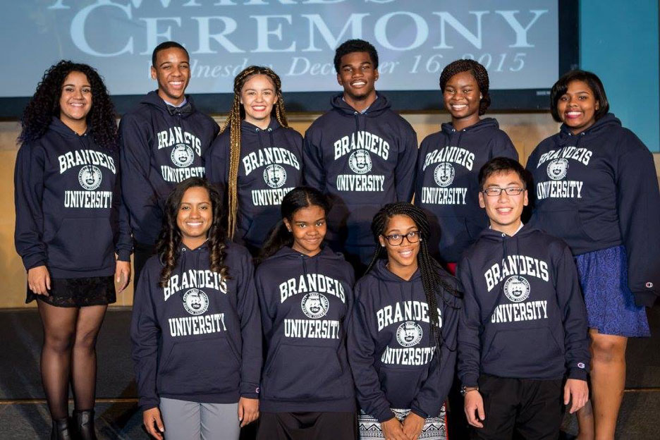 10 students wearing Brandeis sweatshirts pose for the camera