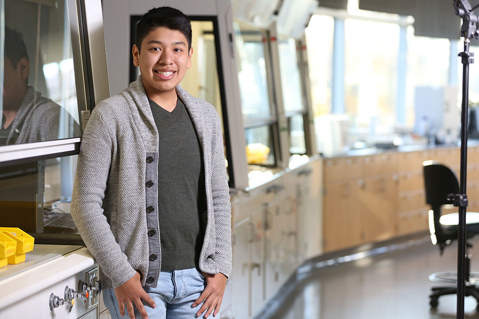 Keven Macareno stands in a lab