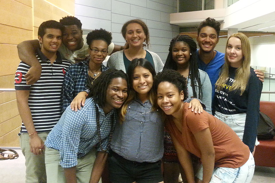 A group of students smiles and poses for the camera