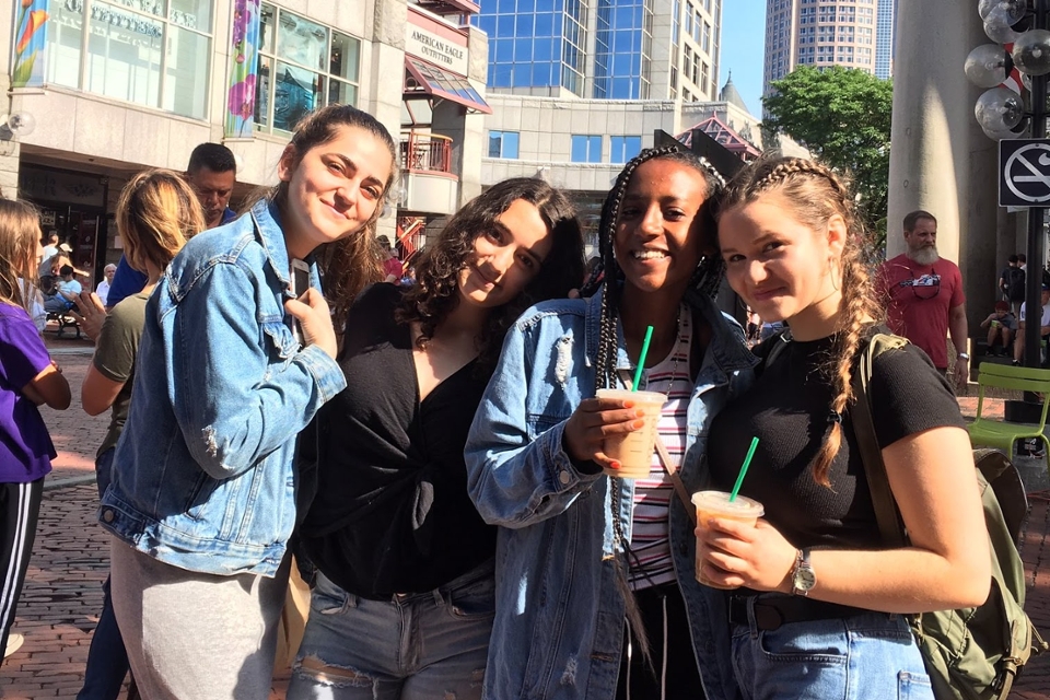 Precollege students pose together to smile for the camera in Boston