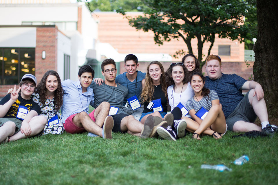 Students sit in a group outside