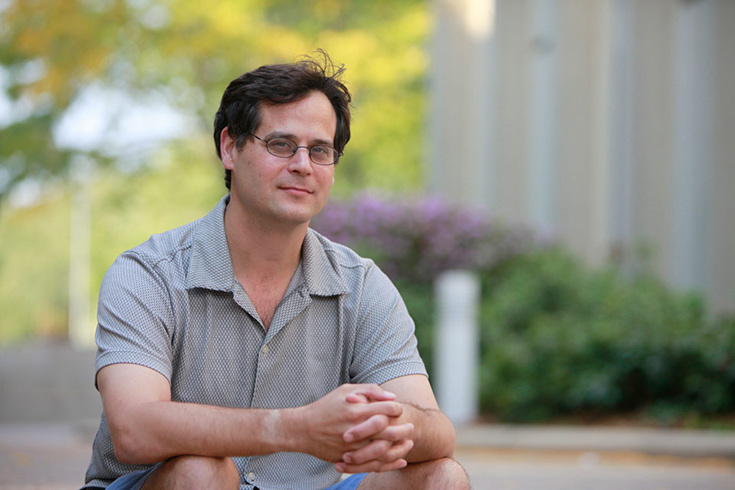 Donald Katz sitting on a step outside