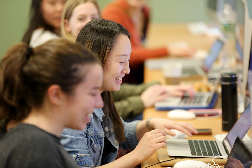 smiling students at computers in Teresa Mitchell's class