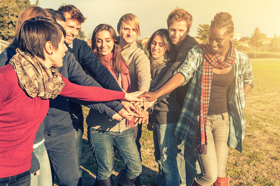 group of hands on top of one another