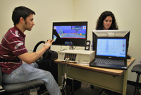 students seated at computer simulating driving