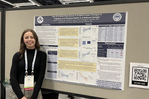 Lifespan Lab researchers in front of a lab poster.