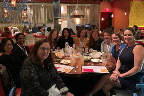 A group of people having dinner at a restaurant.