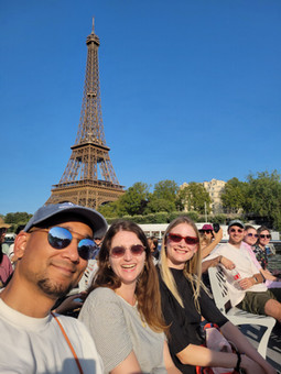 Jenny with her colleagues seated infront of the Eiffel Tower.