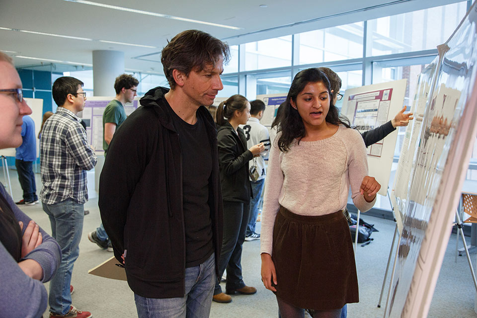 Student presenting a poster to Jane Kondev, Professor of Physics
