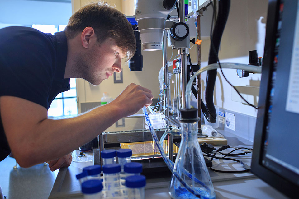 Student using equipment in a lab