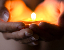 A candle held in someone's hands