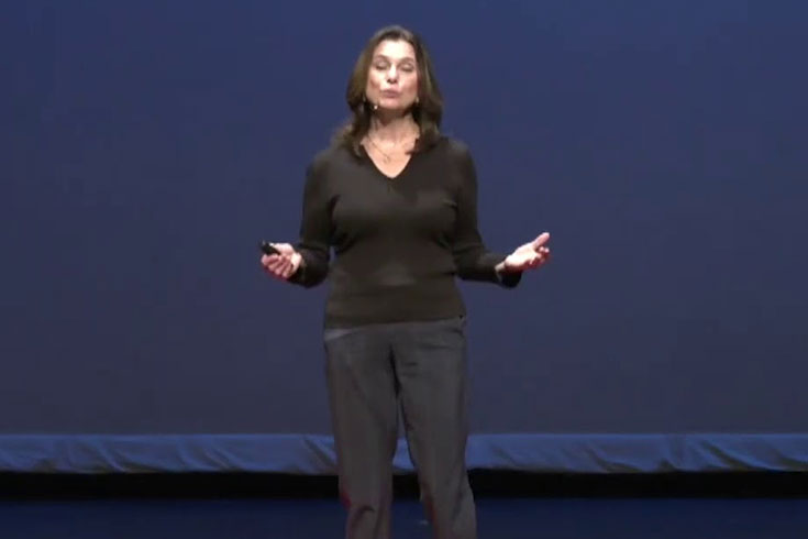 Kristen Lucken stands on a stage