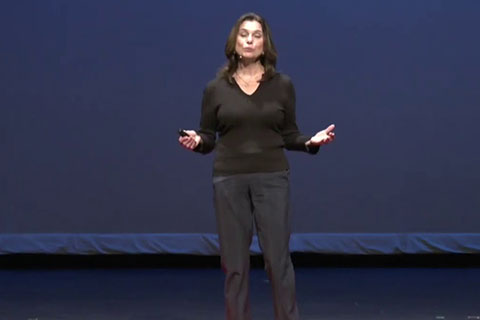 Kristen Lucken stands on a stage