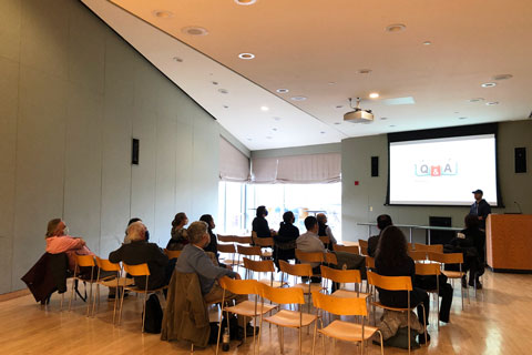 wide shot of researcher giving presentation