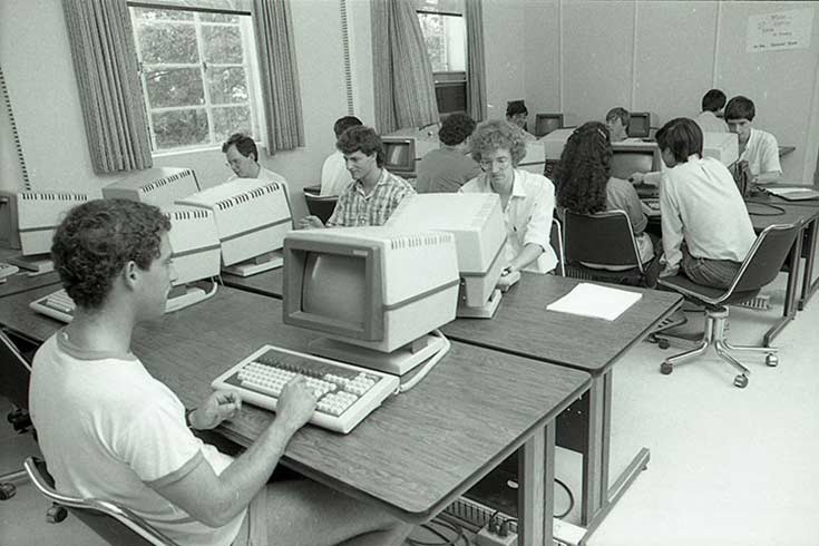 Black and white photo of people using computers