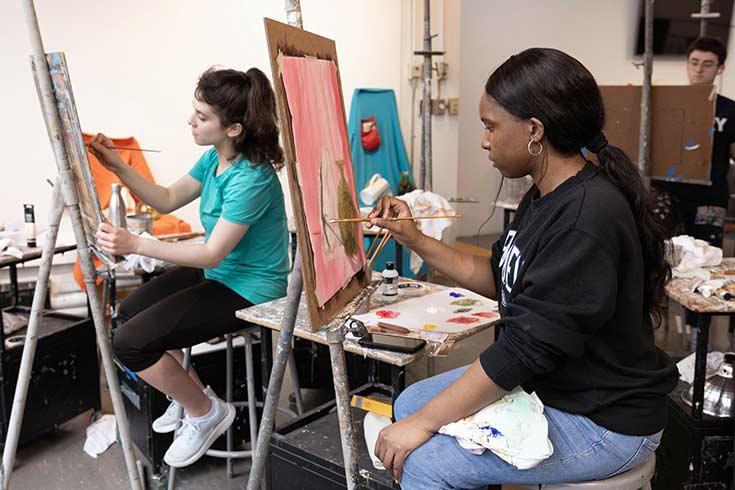 Color photo of people painting in an art studio