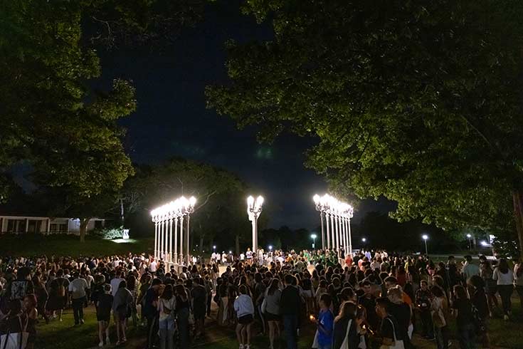 Colorful photo of the class of 2027 outside near the Light of Reason art installation