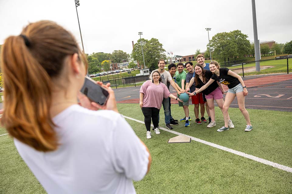 Students pose for a photo during a kickball game