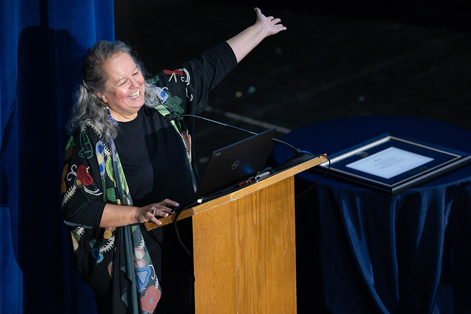 Robin Wall Kimmerer speaking at a podium