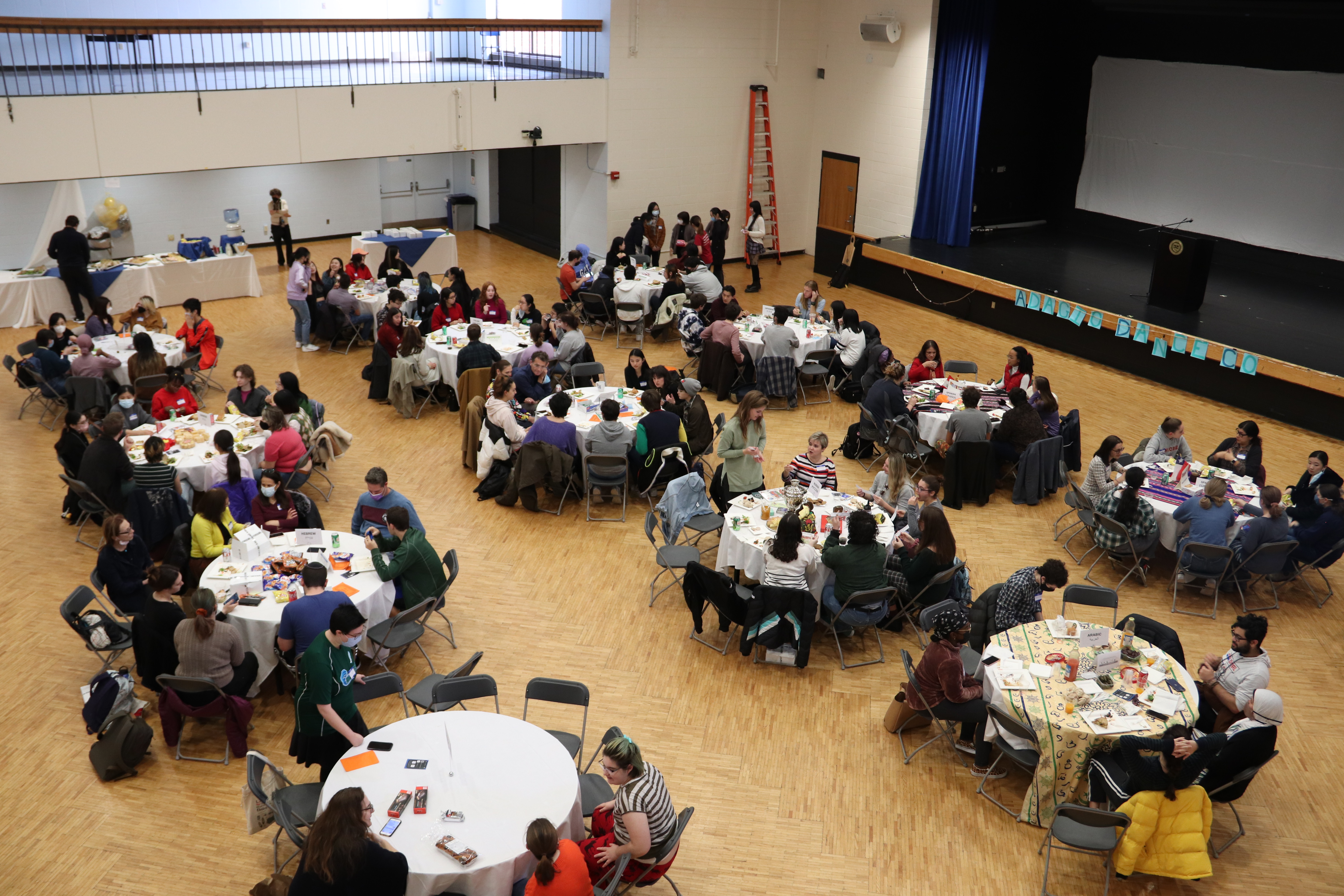photo of tables of attendees at all language lunch