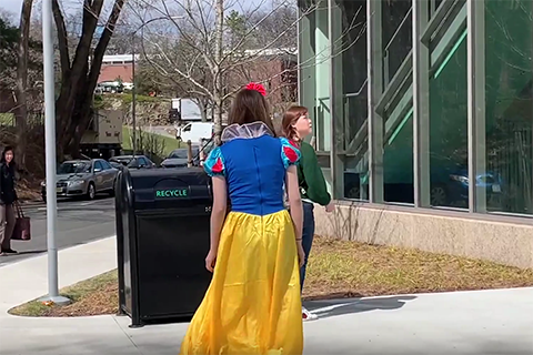 a student dressed as snow white and another female student talking on campus