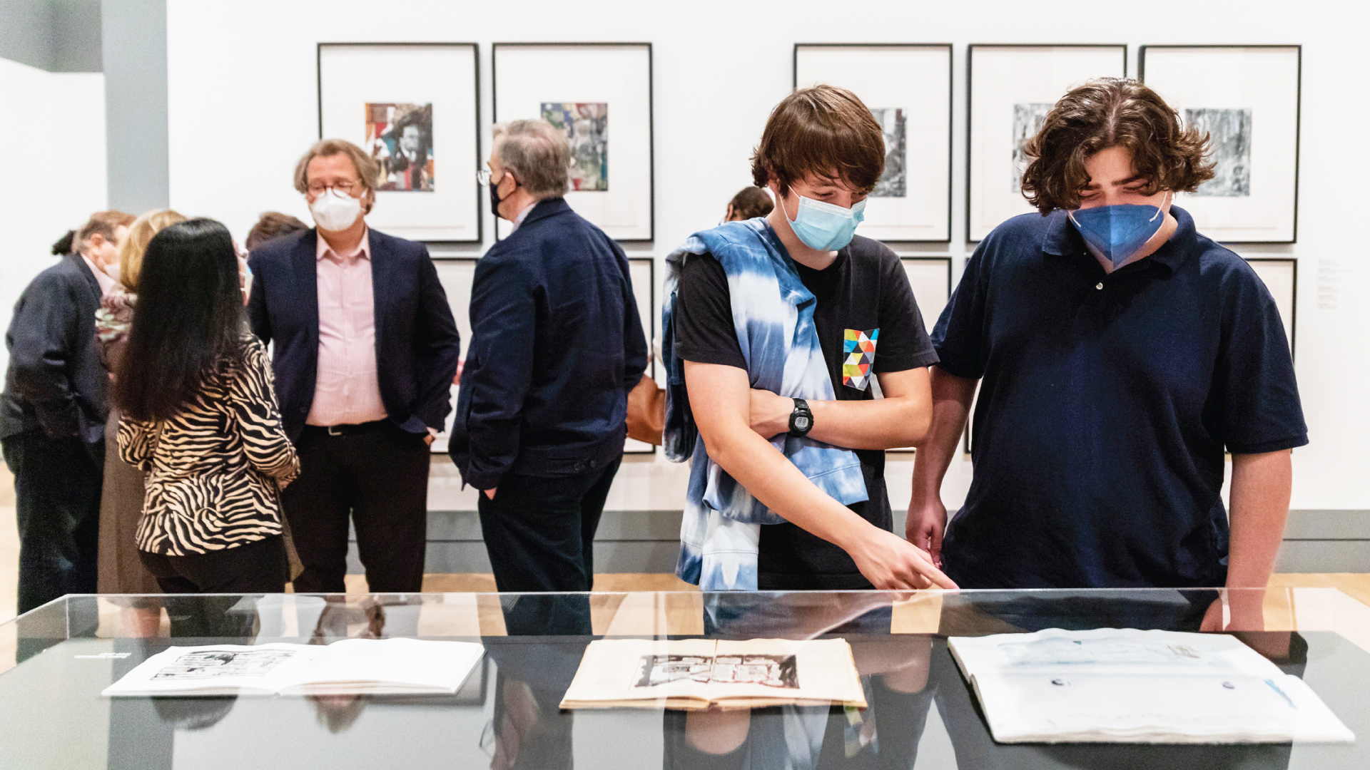 Students look at notebooks by artist Peter Sacks in the museum gallery