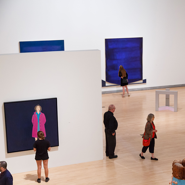 Installation view of Rose Art Museum exhibition Passage from above. People in galleries looking at works on view. 