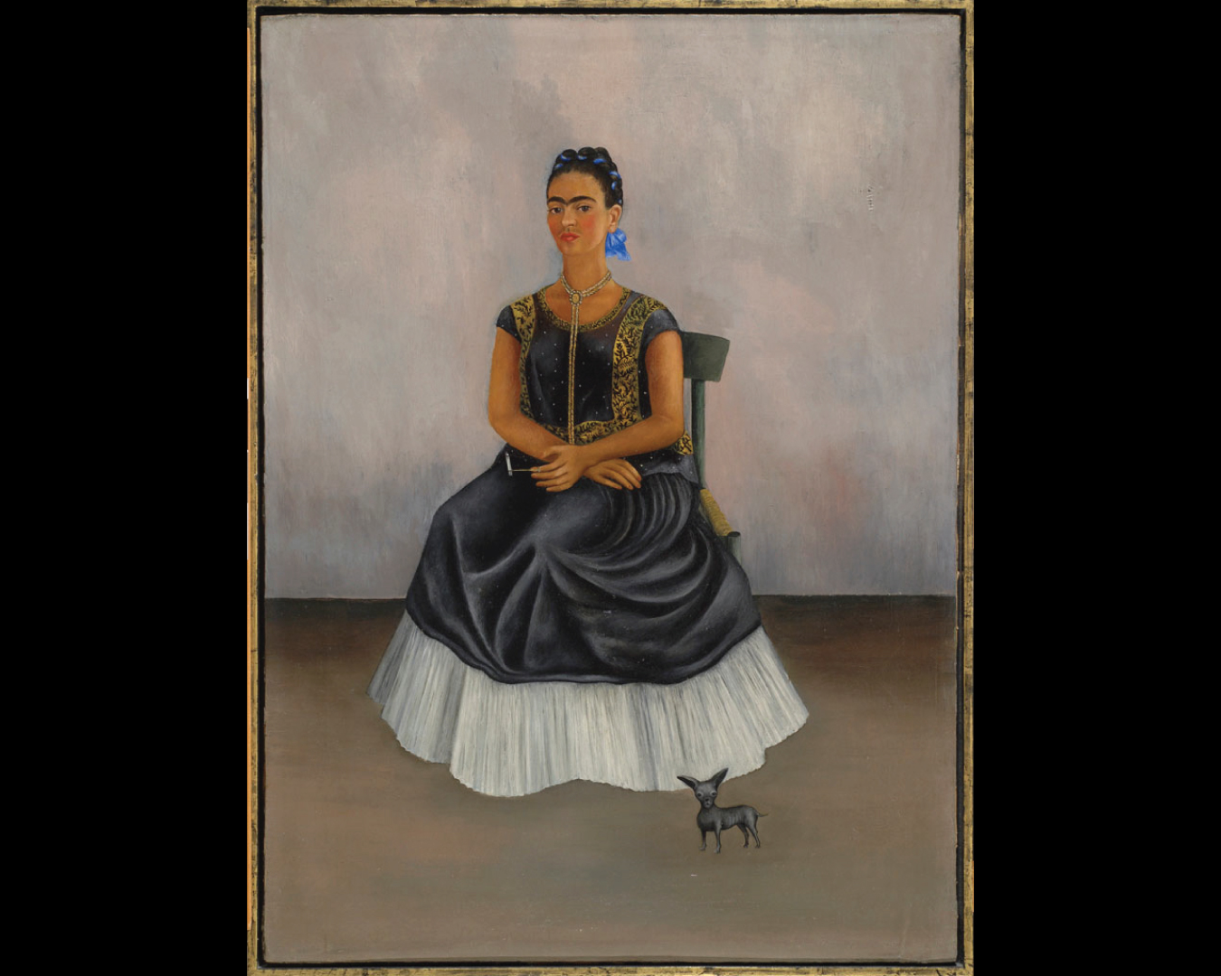 1938 self-portrait of Frida Kahlo seated in a straw chair wearing a huipil (or tunic) smoking a cannabis cigarette, with a hairless dog at her feet.